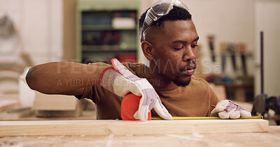 Buy stock photo Carpenter, planning and black man with tape measure in workshop, construction process and precision. Tools, carpentry and woodworker with plank for creative project, material preparation and craft