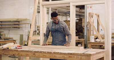 Buy stock photo Carpenter, man and woodwork in workshop with timber, sandpaper or project for furniture manufacturing. Woodworker, black person and artisan in factory with carpentry equipment, PPE and craftsmanship.