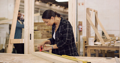 Buy stock photo Carpenter, woman and tape measure in workshop with timber, woodwork and furniture manufacturing project. Woodworker, person and plank measurement in factory with carpentry, tools and craftsmanship.