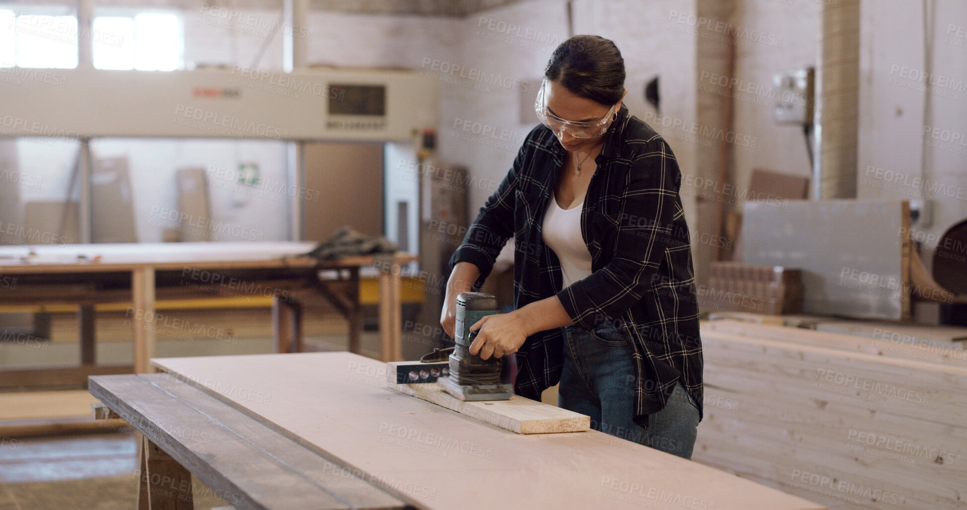 Buy stock photo Carpenter, woman and sanding machine in workshop with woodwork project, furniture production and craft. Artisan, person and manufacturing with glasses, electric tools and carpentry gear for timber.