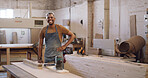 Portrait, carpenter or man in workshop with woodwork, electric tools or furniture manufacturing project. Confident, black person and smile in factory with carpentry gear, equipment and craftsmanship.