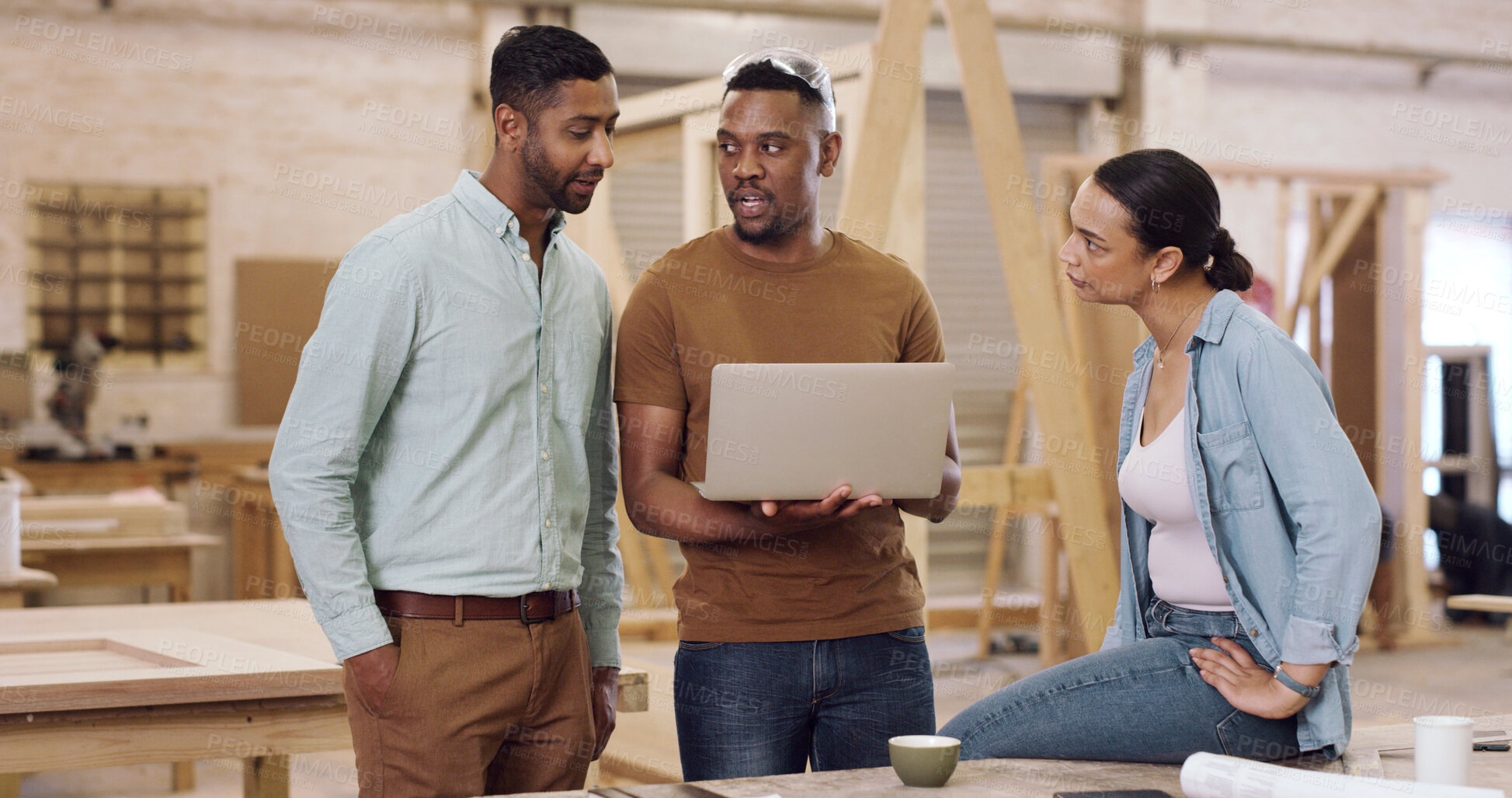 Buy stock photo Carpenter, laptop and people in meeting, conversation and planning for inventory management. Feedback, men and woman in workshop, discussion and tech for production process and manufacturing schedule