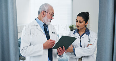Buy stock photo Doctors, tablet and team with review at hospital with discussion, checklist or insight for medical report. Mentor, man and woman with tech, application and feedback for healthcare services at clinic