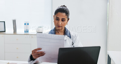 Buy stock photo Documents, healthcare and laptop with doctor in office at hospital for online planning or research. Computer, medical and paperwork with Indian woman in clinic for administration, report or study
