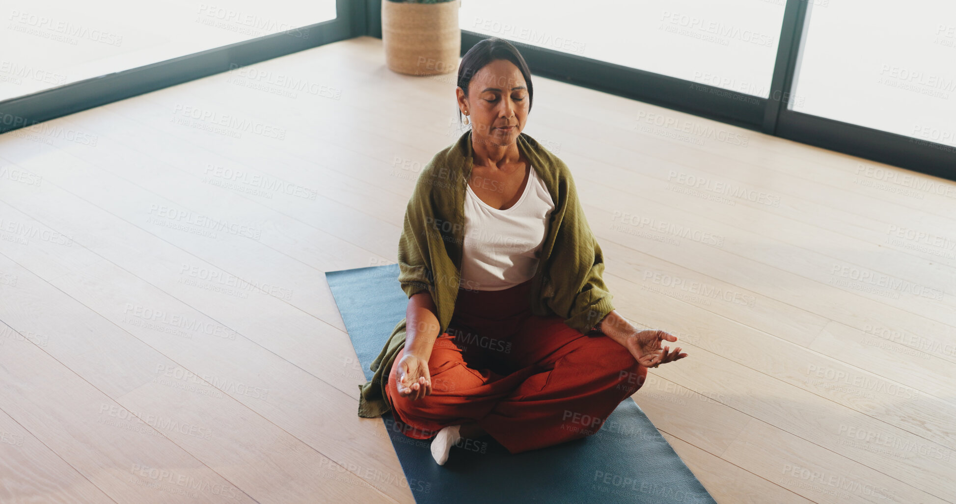 Buy stock photo Calm, yoga and woman with meditation in studio for inner peace, grounding practice and zen. Above, mature person and lotus pose on mat for mental health, mindfulness and holistic wellness with space