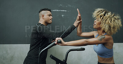 Buy stock photo Woman, personal trainer and high five with bike at gym for fitness, exercise and cycling success. Tired, female person and coach with bicycle for celebration, training achievement and wellness goals