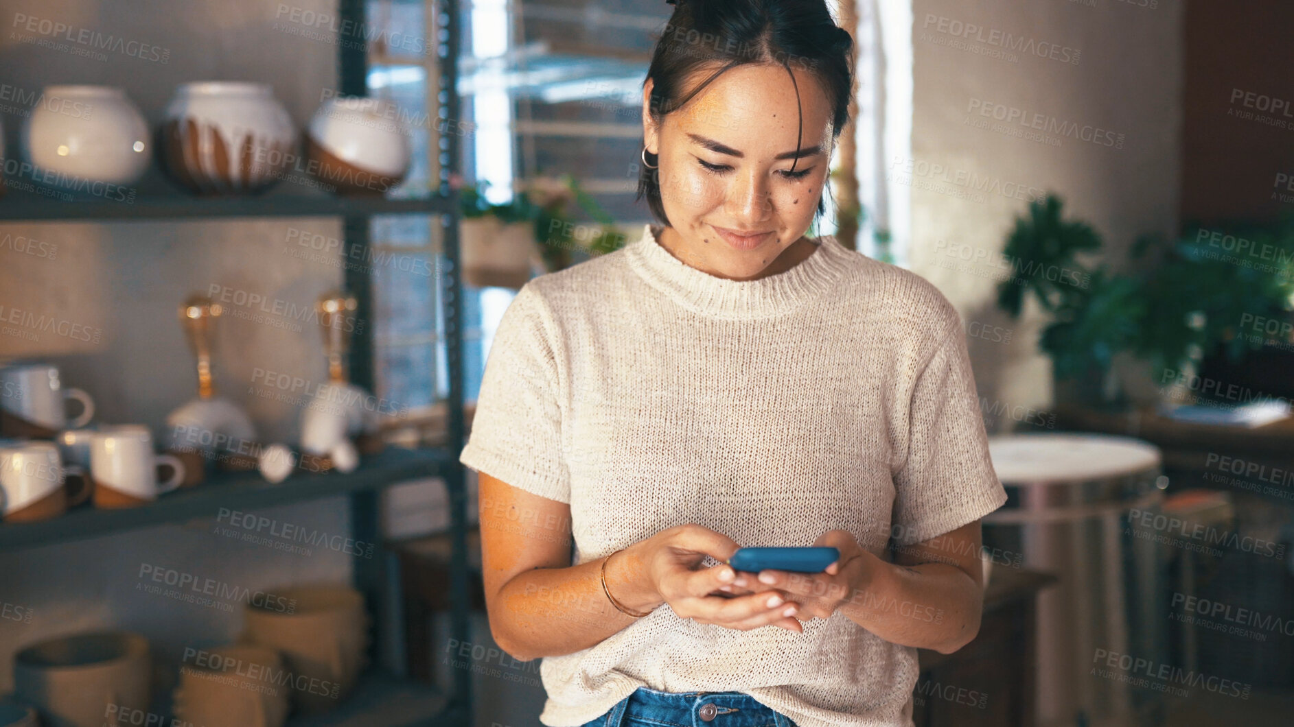 Buy stock photo Phone, planning and text message with woman in pottery boutique for management of small business. App, startup and typing with happy store owner in ceramics gallery for decoration or retail sale