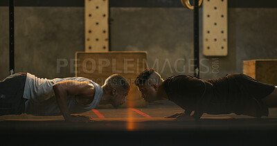 Buy stock photo Fitness, men and push up exercise at gym for core stability, strength training and muscle development. Teamwork, people and personal trainer with functional workout in dark health club for endurance