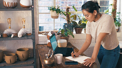 Buy stock photo Pottery, laptop or woman in shop with notes, stock control or delivery schedule in clay store. Writing, notebook or owner with technology, inventory management or order checklist in ceramic business.