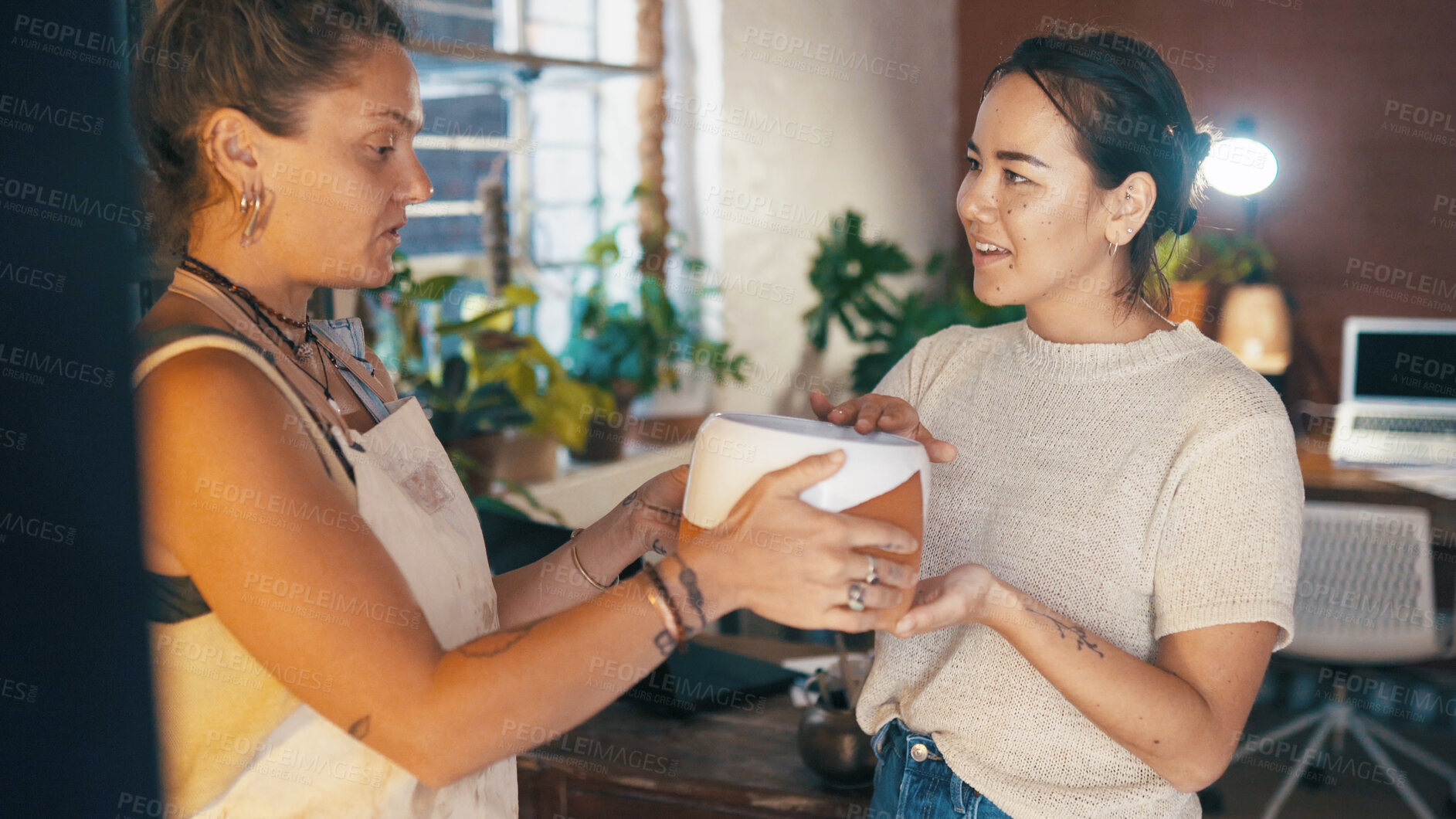 Buy stock photo Customer service, shopping and women with pottery for assistance, help or show product. People, ceramics store and owner with client for sale, smile or giving pot for retail advice in small business