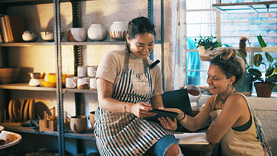 Buy stock photo Reading, ceramic or team in store with tablet, creative insight or customer review in clay shop. Partnership, women or owners with tech, consumer feedback or design planning in pottery business.