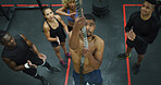Applause, fitness and rope climbing with man in gym for challenge, development or progress from above. Action, power and strength training with people clapping in health club together for motivation