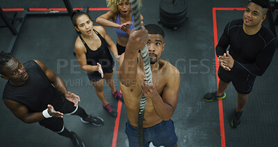 Buy stock photo Applause, fitness and rope climbing with man in gym for challenge, development or progress from above. Action, power and strength training with people clapping in health club together for motivation