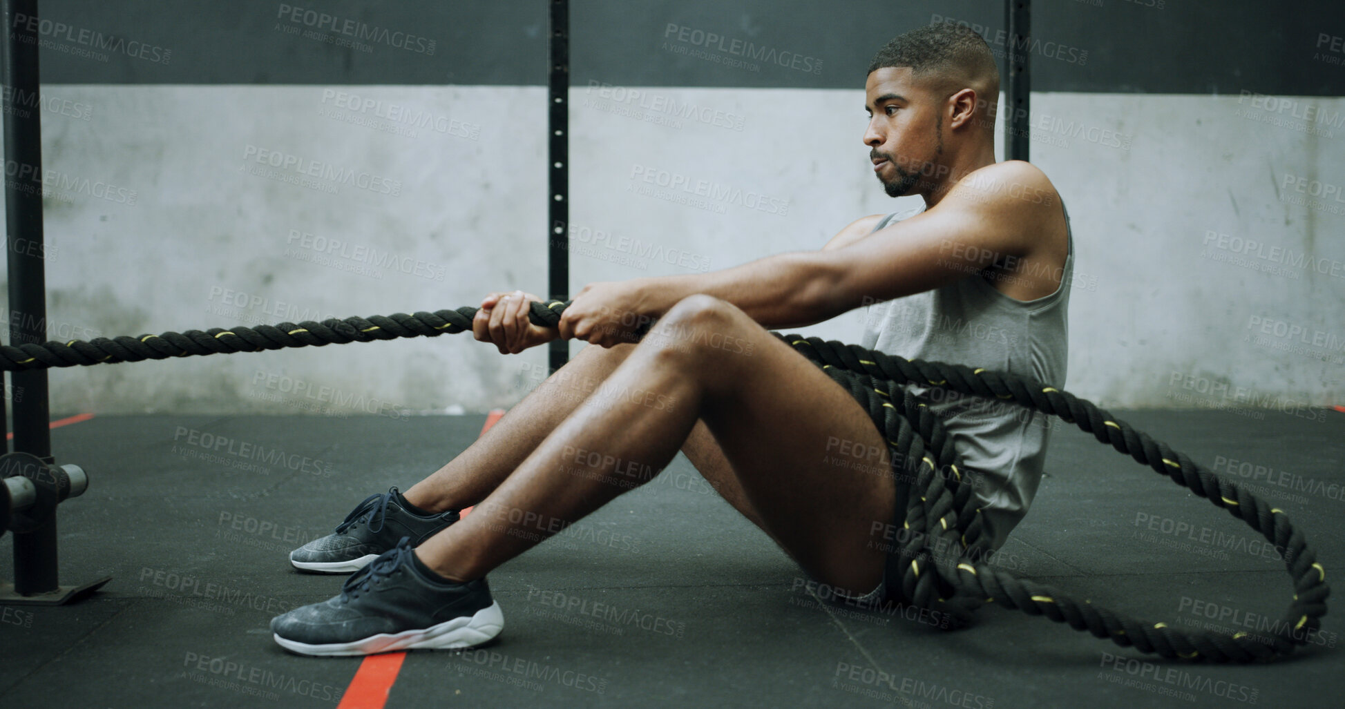 Buy stock photo Man, battle ropes and workout on gym floor with pull, intense exercise and resilience with challenge. Person, fitness and power with breathing, resistance and training for muscle benefits with gear