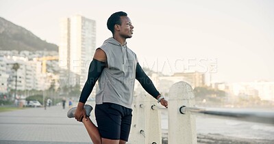 Buy stock photo Black man, fitness and stretching with leg on promenade for workout preparation or outdoor training. Active, male person or runner getting ready with warm up for exercise, health or wellness on coast