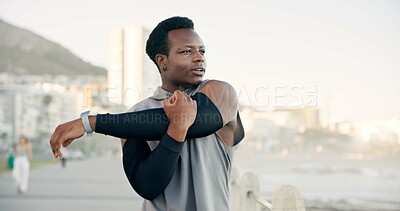 Buy stock photo Man, fitness and stretching with arm on promenade for workout preparation or outdoor training. Active, male person or runner getting ready with warm up for exercise, health or wellness on coast