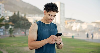 Buy stock photo Man, phone and texting with fitness on beach promenade with smile, break and monitor on application. Person, runner and happy with smartphone, check notification and outdoor for exercise on boardwalk