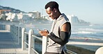 Black man, phone and texting with fitness on beach promenade with smile, break and application. Person, runner and happy with smartphone, check notification and outdoor for exercise on boardwalk