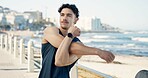 Man, fitness and stretching with arms on promenade for workout preparation or outdoor exercise. Active, male person or runner getting ready with warm up on beach or ocean coast for health or training