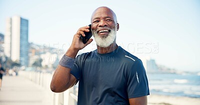 Buy stock photo Boardwalk, fitness and mature man with phone call, communication and share location for workout training. Speaking, outdoor space and African athlete with mobile for exercise update, break and smile