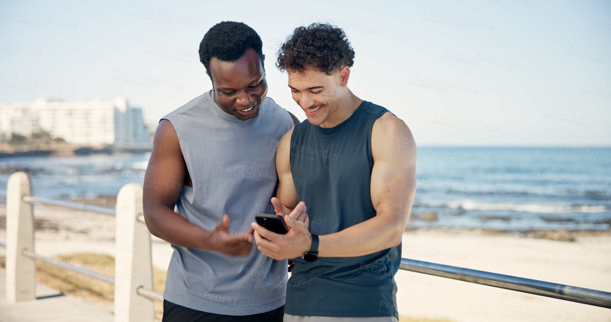Buy stock photo Beach, athlete and men with smartphone, break and check exercise stats on website, happy and online. Ocean, runner and people with mobile for fitness progress, space or friends with tech in nature