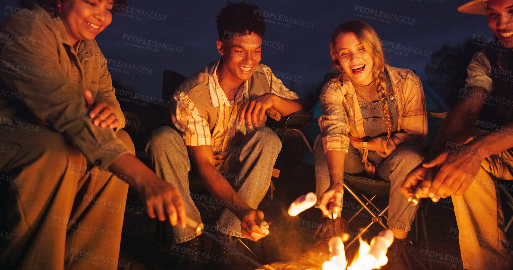 Buy stock photo Friends, camping and roast marshmallow at night with campfire, adventure and social gathering. Smile, people and flames for smores snack, group reunion and bonding together for vacation in wilderness