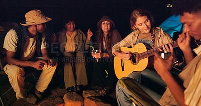 Buy stock photo Night, friends and camping with guitar for music, relax and singing on weekend getaway. Men, woman and string instrument at fire for late bonding, holiday and favorite song at outdoor campsite