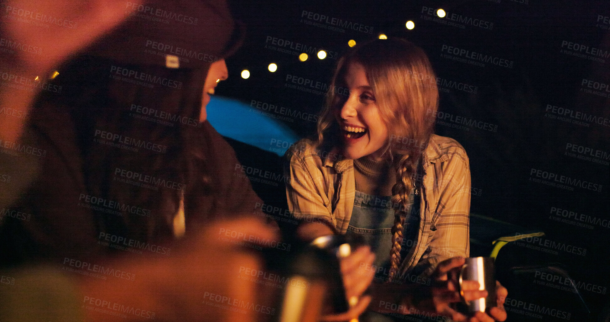 Buy stock photo Friends, camping and smile with coffee at night for travel, funny and social gathering. Outdoor, people and group reunion with joke, laughing or bonding together on vacation in wilderness and evening