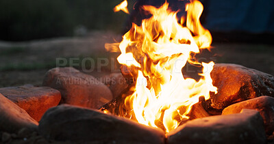 Buy stock photo Night, outdoor and wood with flames for bonfire, smoke and embers burning for camping travel holiday. Evening light, heat source and glowing log with sparks in nature, rocks and trip for weekend