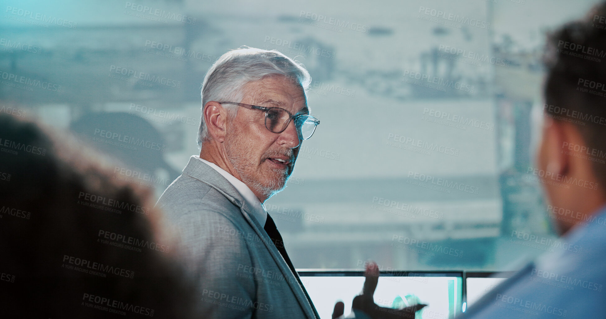 Buy stock photo Man, private investigator or discussion with team in control room for security surveillance. Mature person, officer or inspector with cctv footage for safety breach, protocol or precaution in office