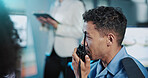Man, security guard or talking with radio for safety measure or protection in control room. Male person, officer or night watch with signal response or cctv footage for crime alert or detection