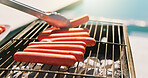 Bbq, hotdog and tongs with hands of person outdoor for cooking, cookout event and barbecue. Summer vacation, weekend break and grill with cook and roast on patio of home for meat, lunch and food