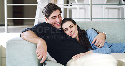 Buy stock photo Watching tv, couple and hug on break, love and bonding with movies, home and affection with partner. People, smile and streaming film on weekend, man and embrace with woman or entertainment in lounge
