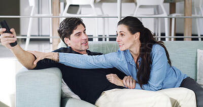 Buy stock photo Home, watching tv and couple on couch, competitive and bonding together for fun, love and relax. Apartment, man and woman on sofa, remote control and entertainment for break, playing and happiness