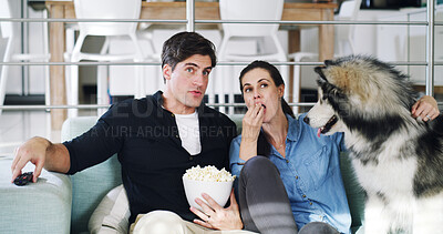 Buy stock photo Couple, relax and watching tv with popcorn on couch with remote control, bonding and dog in home. Man, woman and discussion with pet for movie, film or snacks for streaming in lounge at apartment