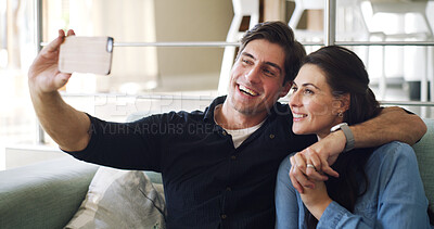 Buy stock photo Happy couple, selfie and hug on couch in home with bonding, connection or care with web post. Man, woman and smile with partner, photography or embrace with love for social media on sofa at apartment