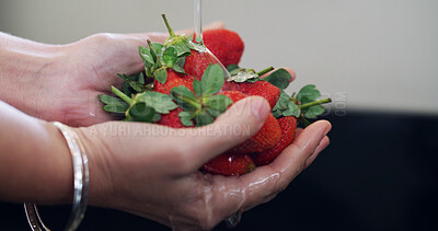 Buy stock photo Hands, water and woman in kitchen, strawberry for nutrition and cleaning to remove dust. Closeup, home and fruit for health benefits, person and rinse for bacteria, diet and vitamin c for wellness