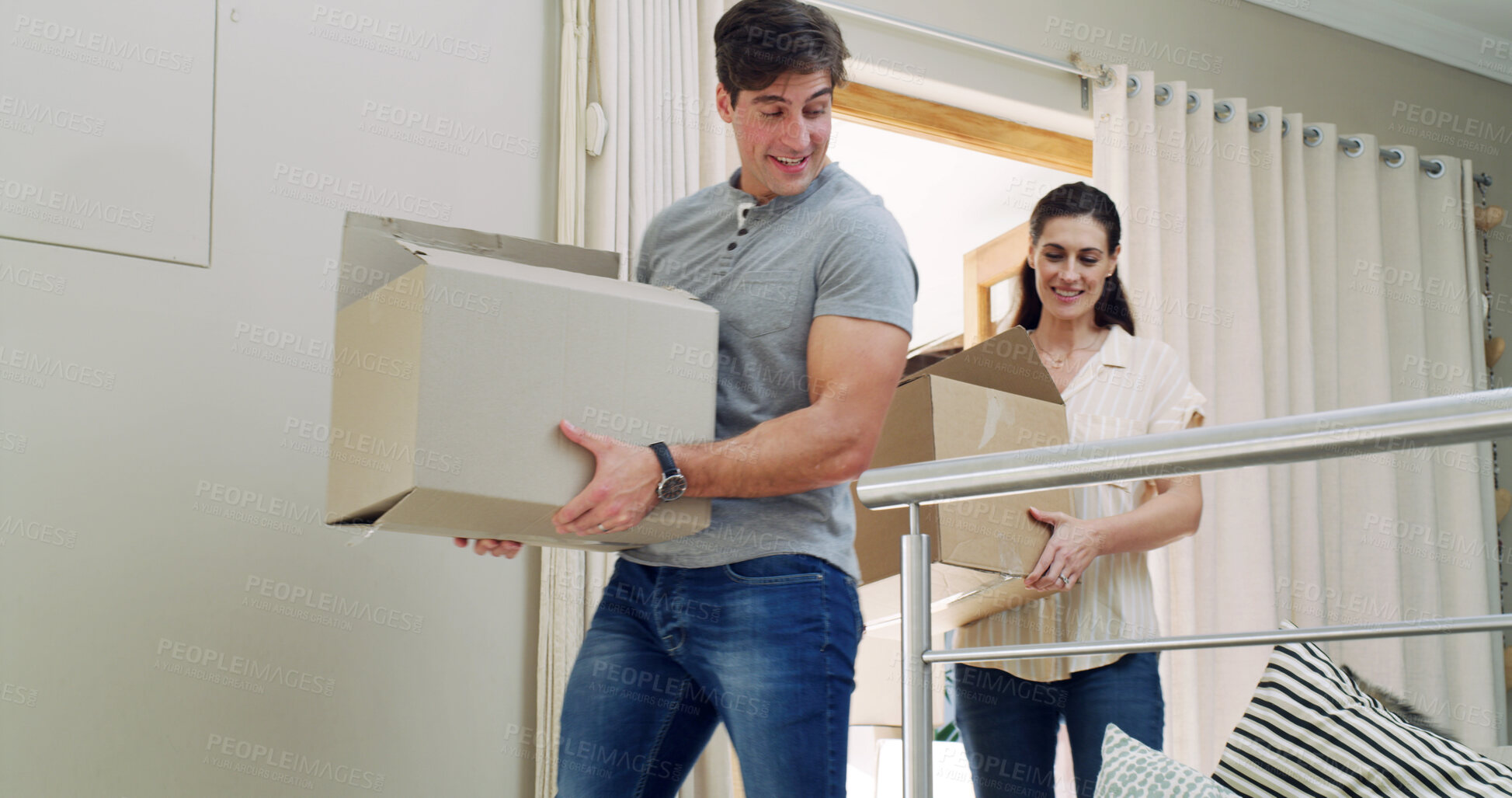Buy stock photo Walking, happy and couple with boxes in new home for moving to property, apartment and house. Homeowner, relocation and man with woman excited for real estate investment, purchase and mortgage