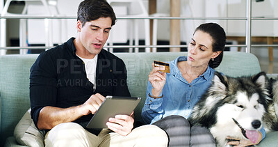 Buy stock photo Talking, credit card and couple on sofa, tablet for animal ecommerce and website info for canine care. Payment, man and woman on couch, home or app for online shopping or purchase for dog maintenance