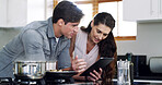 Talking, cooking or couple in kitchen, tablet for online recipe or app for nutrition info. Home, man or tech for social media, woman or reading instructions for health meal, discussion or ingredients