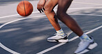 Person, legs and playing with ball on basketball court for game, sport or outdoor fitness. Active, player or movement with technique, lines or shoes for tournament match, speed or motion on pitch