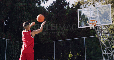 Buy stock photo Man, basketball and playing with net on court for score, point or outdoor match in nature. Active, male person or throw with aim, technique or swish shot for fitness, sport or playful game on pitch