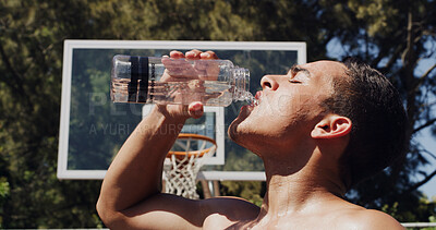 Buy stock photo Man, basketball and drinking with water bottle for hydration, rest or sport break on court. Active, male person or player with mineral liquid for natural sustainability, fitness recovery or health