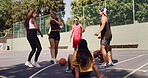 Group, break and people excited on basketball court for collaboration, conversation or support. Training game, teamwork or outdoor athletes for solidarity, fitness or community in sports match