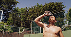 Man, pour and water on basketball court for outdoor sport, competition or fitness game. Athlete, splash and sweat with liquid for health, hydration and training in summer for exercise or workout
