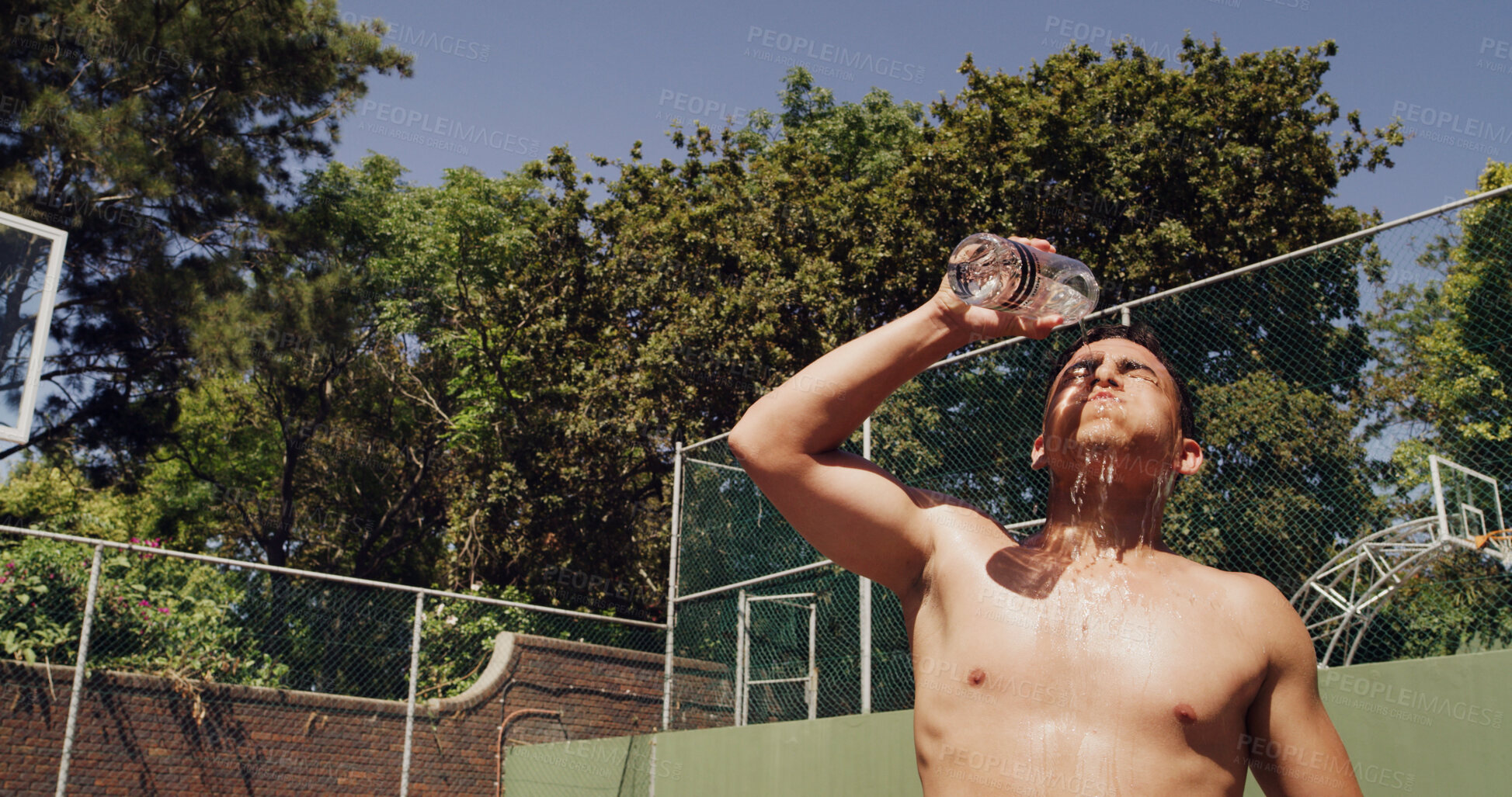 Buy stock photo Man, pour and water on basketball court for outdoor sport, competition or fitness game. Athlete, splash and sweat with liquid for health, hydration and training in summer for exercise or workout