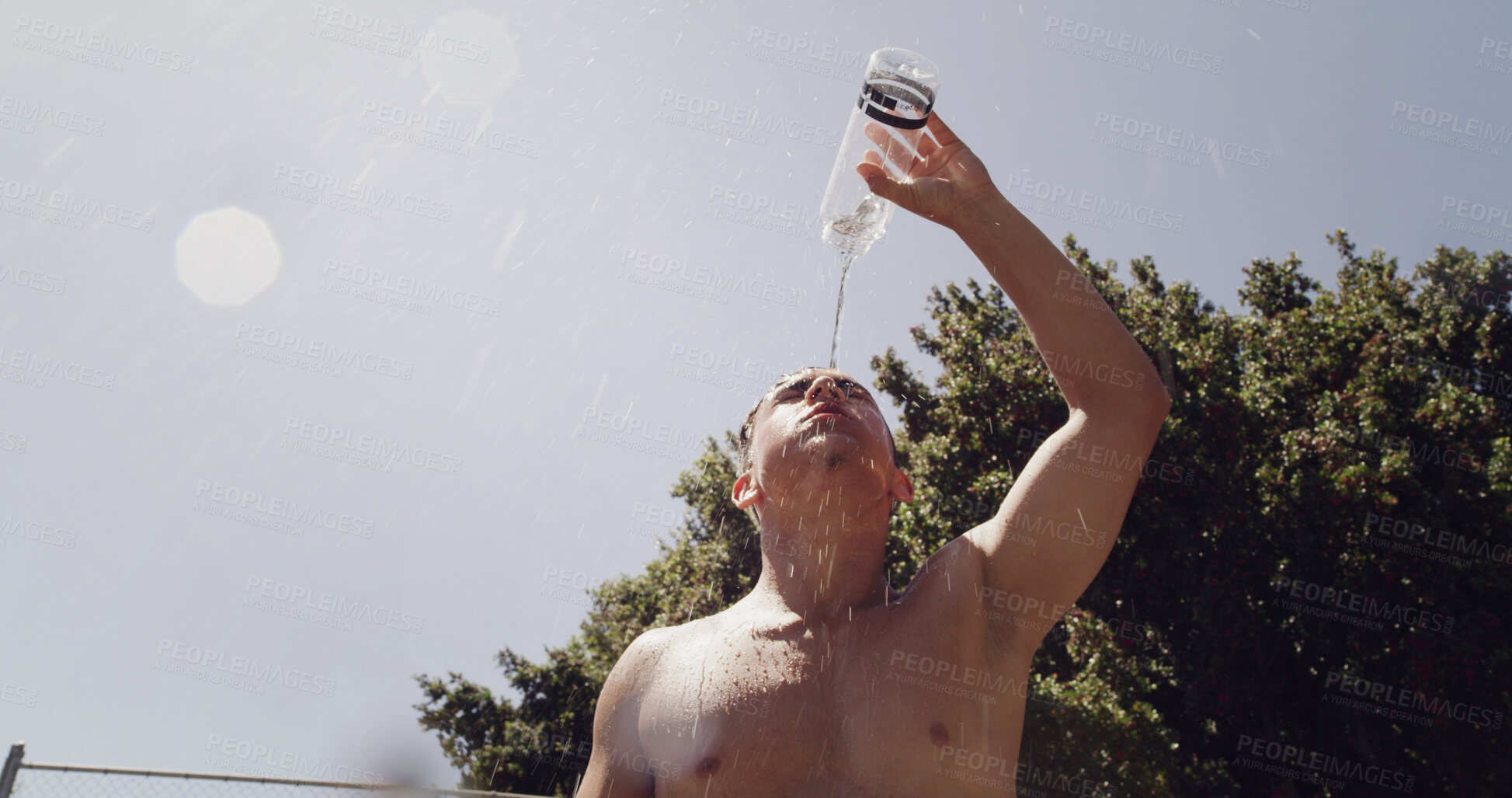 Buy stock photo Man, low angle and water on basketball court for outdoor sport, competition or fitness game. Athlete, splash and sweat with liquid for health, hydration and training in summer for exercise or workout
