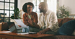 Speaking, document or happy couple with laptop on sofa, budget planning or track expenses for savings. Talk, income statement or mature African people with mortgage payment bills, flare or pc in home