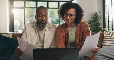 Buy stock photo Reading, paperwork and couple with laptop on sofa, budget planning or track expenses for savings. Banking, income statement or mature African people with mortgage payment, bills review or pc in home