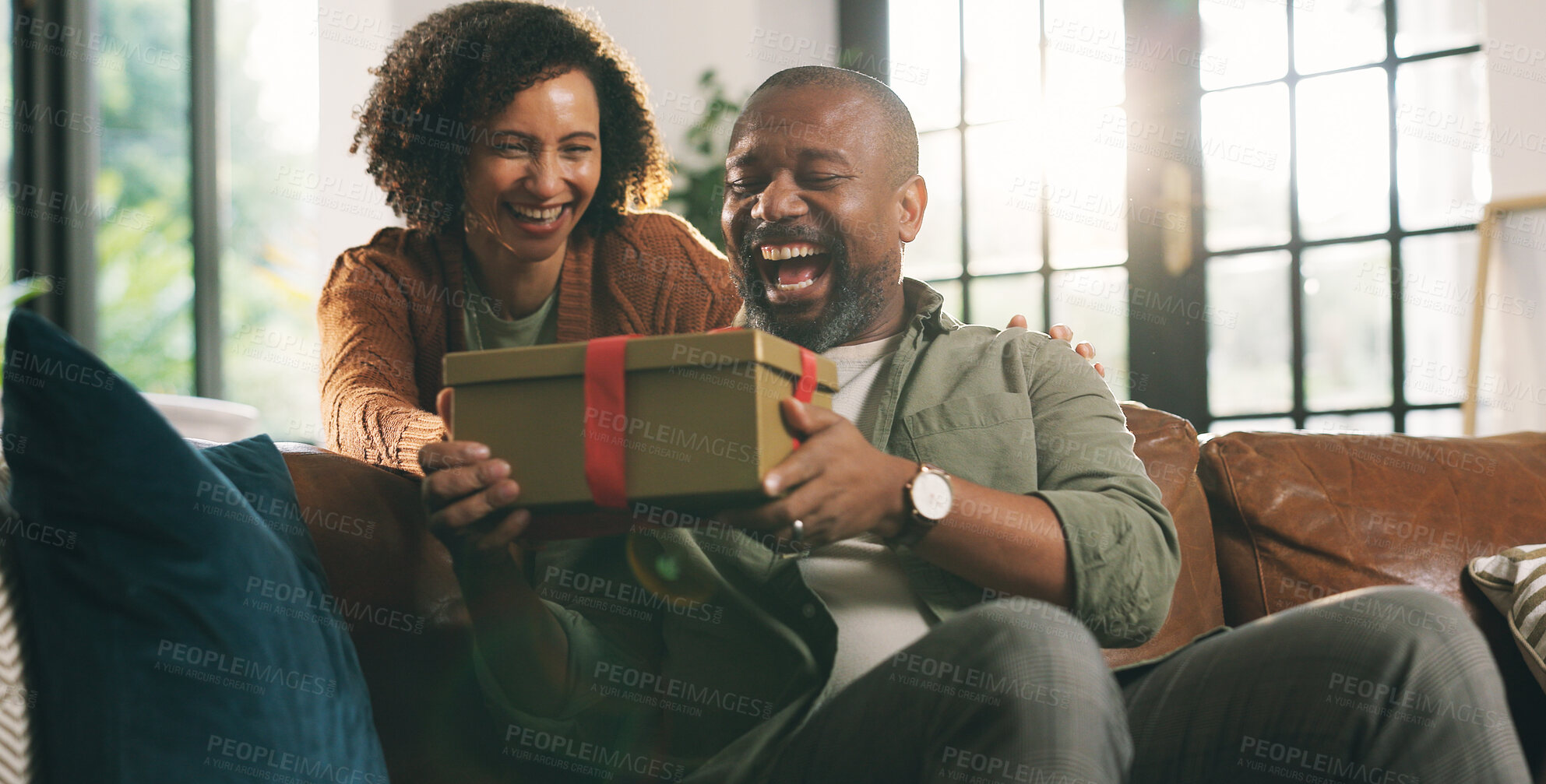 Buy stock photo Surprise, gift box and mature couple on sofa in home for valentines day, anniversary or romance. Happy, wow and woman with present for man with celebration together in living room at apartment.